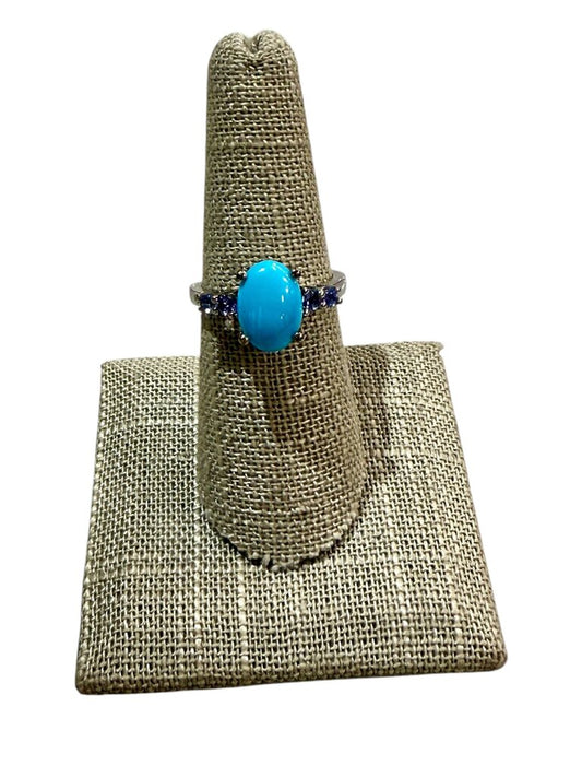 SS OVAL TURQ CTR W/4 TANZ ACCENT STONES ON BAND SZ 7