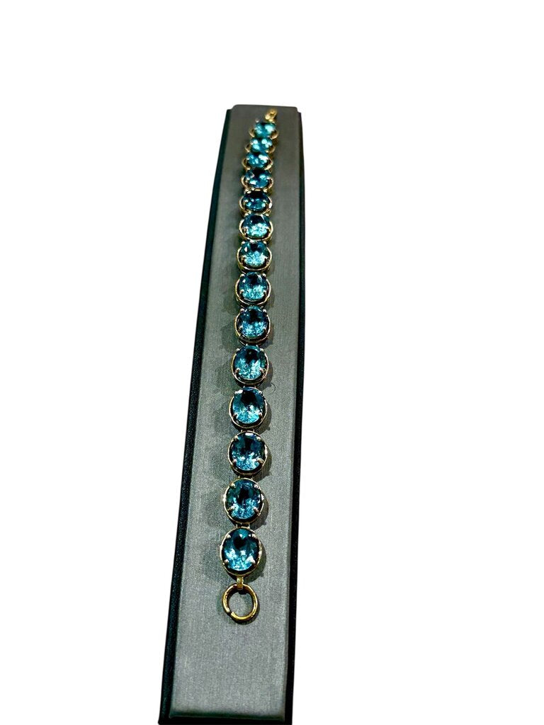 10KT YG OVAL BLUE TOPAZ TENNIS BRACELET