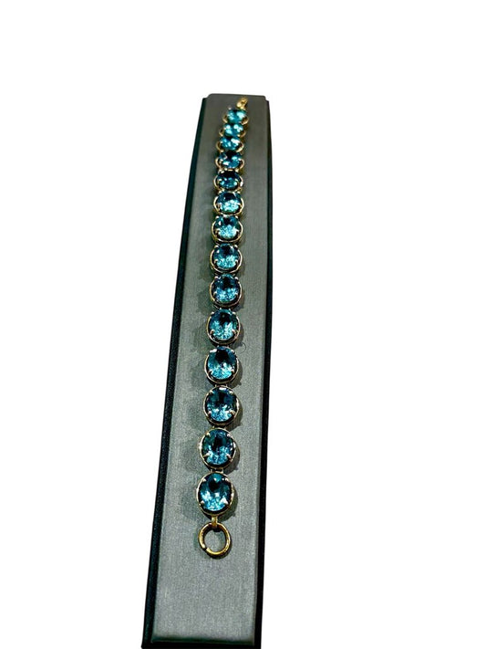 10KT YG OVAL BLUE TOPAZ TENNIS BRACELET