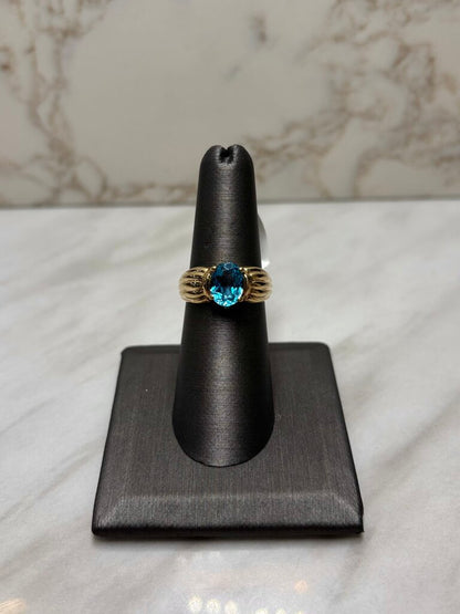 10KT YG OVAL BLUE TOPAZ SHELL LIKE BAND SZ 7