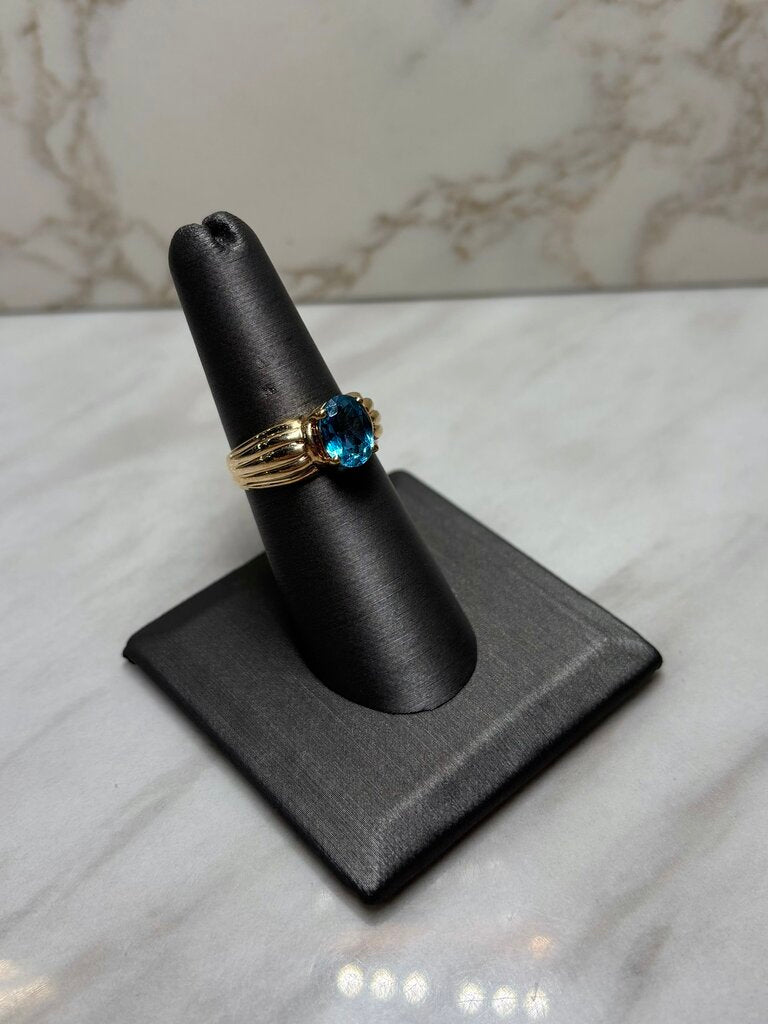 10KT YG OVAL BLUE TOPAZ SHELL LIKE BAND SZ 7